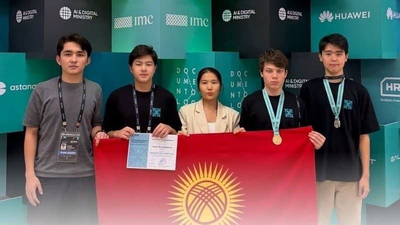 Members of Kyrgyzstan's team holding the national flag, two of them wearing medals